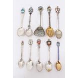 Ten silver/white metal and enamel souvenir spoons