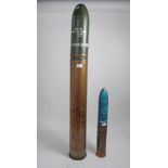 Large 1970s free standing shell case with dummy shell, together with a similar smaller shell, large