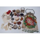 A selection of antique sewing items including novelty pin cushions, tapes measures, thimbles and