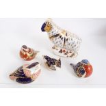 Five Royal Crown Derby porcelain paperweights to include a Ram, and four birds