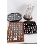 Selection of porcelain thimbles housed in display cabinets and a glass dome, plus two silver