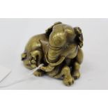 Indo-Chinese bronze and gold splash model of an elephant in recumbent pose 10cm long