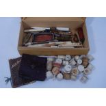 Collection antique sewing items including four carved bone needle cases in the form of umbrellas,