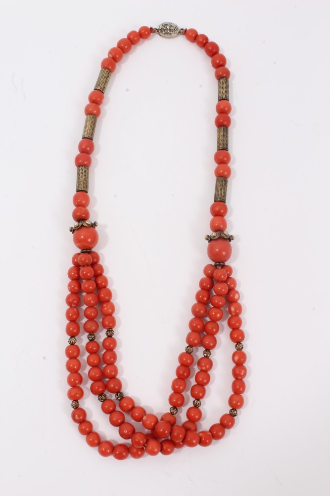 Old Chinese coral necklace with spherical polished beads and metal spacers, terminating with three