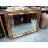 Bevelled wall mirror in ornate gilt frame