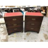 Pair of military style mahogany three drawer chests with leather lined tops