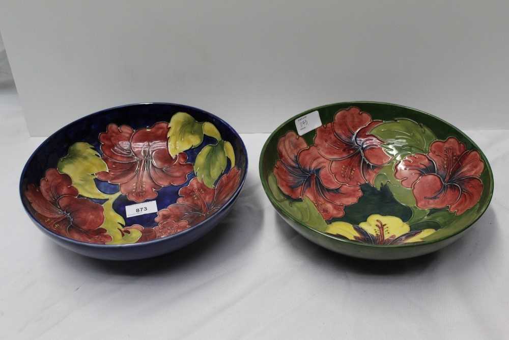 Moorcroft pottery bowl decorated in the Hibiscus pattern on blue ground and one other