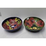 Moorcroft pottery bowl decorated in the Hibiscus pattern on blue ground and one other