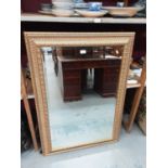 Bevelled mirror in ornate gilt frame