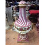 Continental porcelain vase and cover with pink, gilt, floral swag decoration and lion mask handles