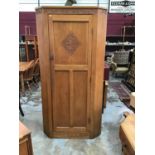 Good quality hand carved and panelled light oak corner wardrobe/ hall cupboard