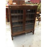 1920's Oak book case enclosed by two leaded glass doors, by G.W. Hicks & Sons Ltd 'Makers