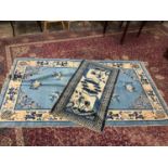 Two 1930s Chinese rugs on blue and cream ground (2)