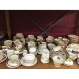 Selection of tea ware cups and saucers plus wicker basket with miniature tea ware