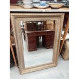 Bevelled wall mirror in ornate gilt frame