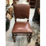 Old oak dining chair with studded leather seat and back, and carved decoration