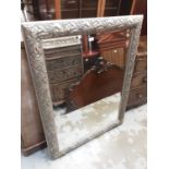Bevelled wall mirror in ornate silvered frame