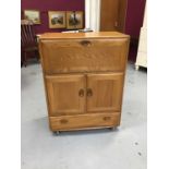 Ercol unit with fall front, two doors and single drawer below