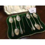 Cased set of six silver tea spoons and sugar tongs by Elkington & Co.