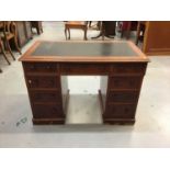 Late Victorian mahogany twin pedestal desk with lined top and nine drawers with bun handles