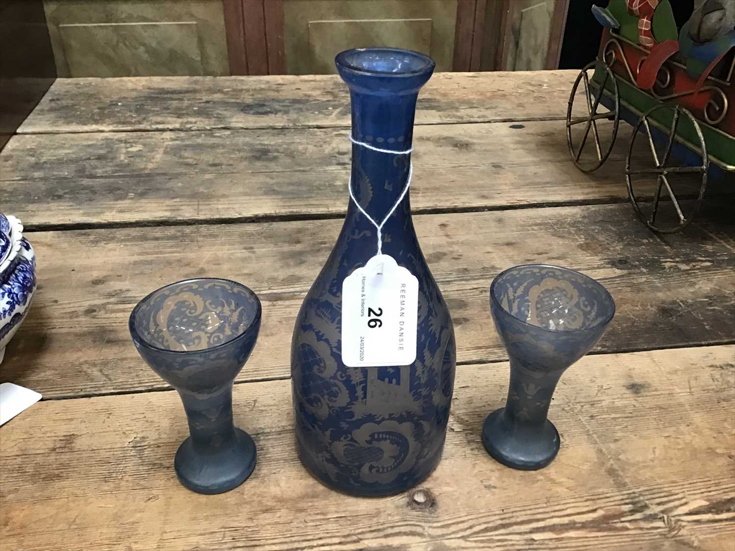 A Bohemian glass decanter and two glasses