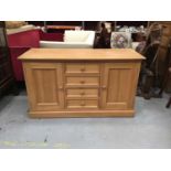 Pine sideboard with four central drawers flanked by two cupboard doors