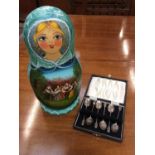 Six silver coffee spoons in case and Russian wooden doll set