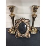 Pair of silver candlesticks, and silver photograph frame
