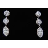 Pair of diamond pendant earrings, each with a marquise cut diamond surrounded by a border of brillia
