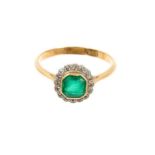 Antique emerald and diamond cluster ring with an octagonal step cut emerald measuring approximately