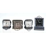 Four Art Deco travel/purse watches, each opening to reveal the watch, in nickel cases.