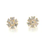 Pair of diamond cluster earrings, each flower head cluster with seven brilliant cut diamonds in gold