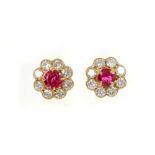 Pair of ruby and diamond cluster earrings, each flower head cluster with a round mixed cut ruby surr