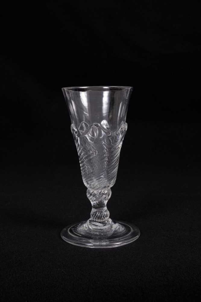 Georgian flamiform wrythen ale glass, the moulded round funnel bowl on a folded conical foot, circa