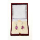 Pair of diamond and pink sapphire pendant earrings, each with a pear cut pink sapphire surrounded by