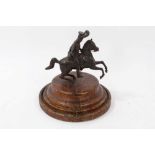 A 19th century bronze figure of a Hussar on horseback, on turned wooden base