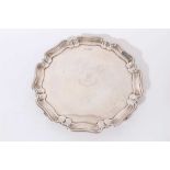 Edwardian silver salver of circular form, with pie crust border.