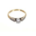 Diamond single stone ring with an old cut diamond in claw setting with diamond set shoulders on 18ct