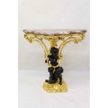Decorative gilt and ebonised pier table with shaped rouge marble top supported by two blackamoors wi
