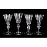 Group of four 18th century continental wine glasses, with etched bowls, Silesian stems and folded fe