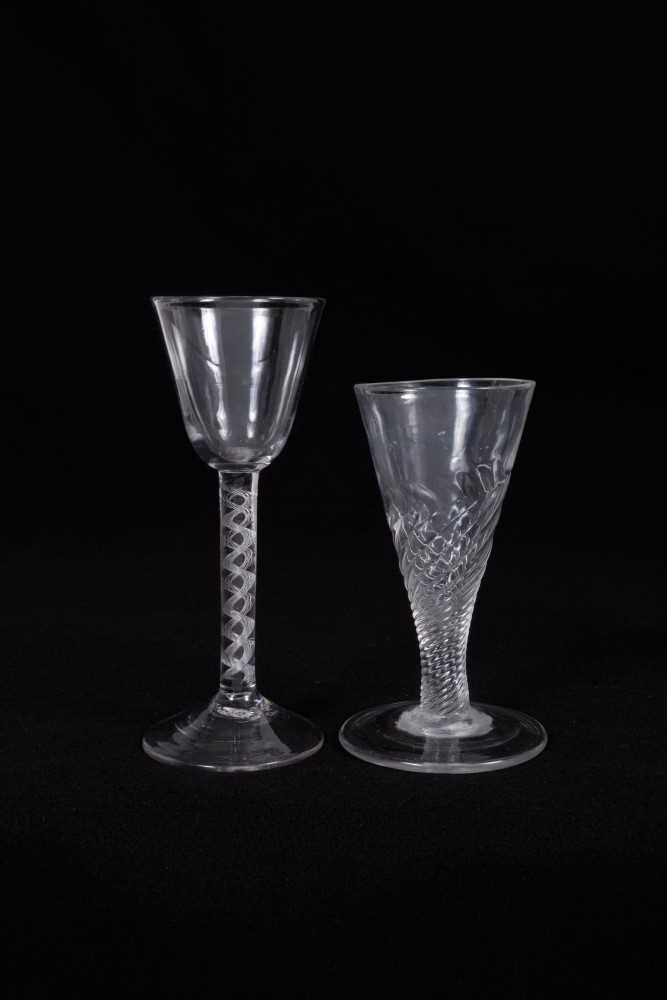 18th century wine glass, the round funnel bowl on an air twist stem, above a high pointed conical fo