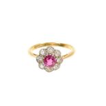 Ruby and diamond cluster ring with a flower head cluster centred with a round mixed cut ruby surroun