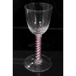 18th century Dutch wine glass with funnel bowl, on white gauze and red and white twist stem on plain