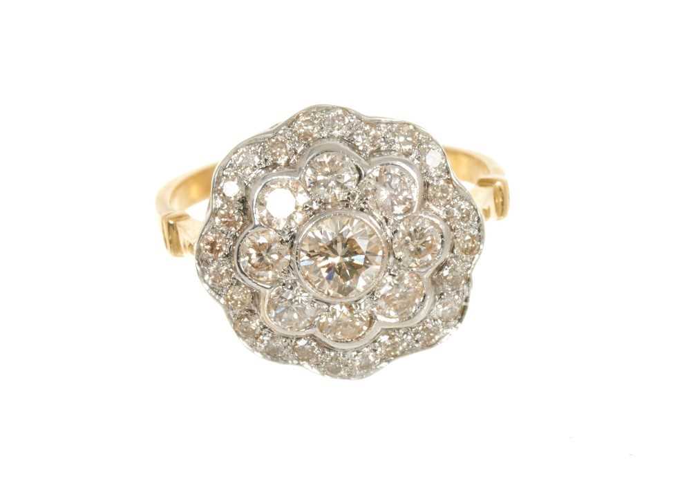 Diamond cluster ring with a flower head cluster of brilliant cut diamonds in grain and rub-over sett