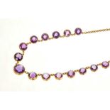 Victorian amethyst necklace with graduated round mixed cut amethysts in gold collet setting