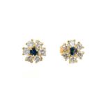 Pair of sapphire and diamond flower head cluster earrings, each with a round mixed cut blue sapphire
