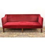 Edwardian sofa upholstered in red velvet on inlaid mahogany legs with brass casters