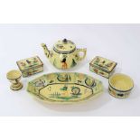 Collection of Quimper faience pottery, painted with figures and foliate patterns on a yellow ground,