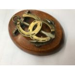 Victorian brass and oak letter clip in the form of an anchor and horseshoe