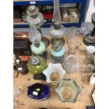 Group of five oil lamps together with shades and chimneys (qty)